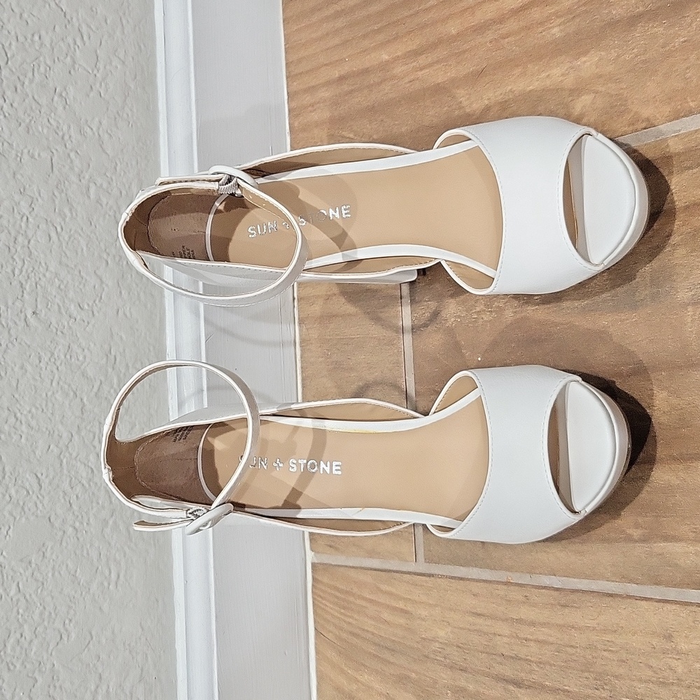 White ankle strap platform heels.